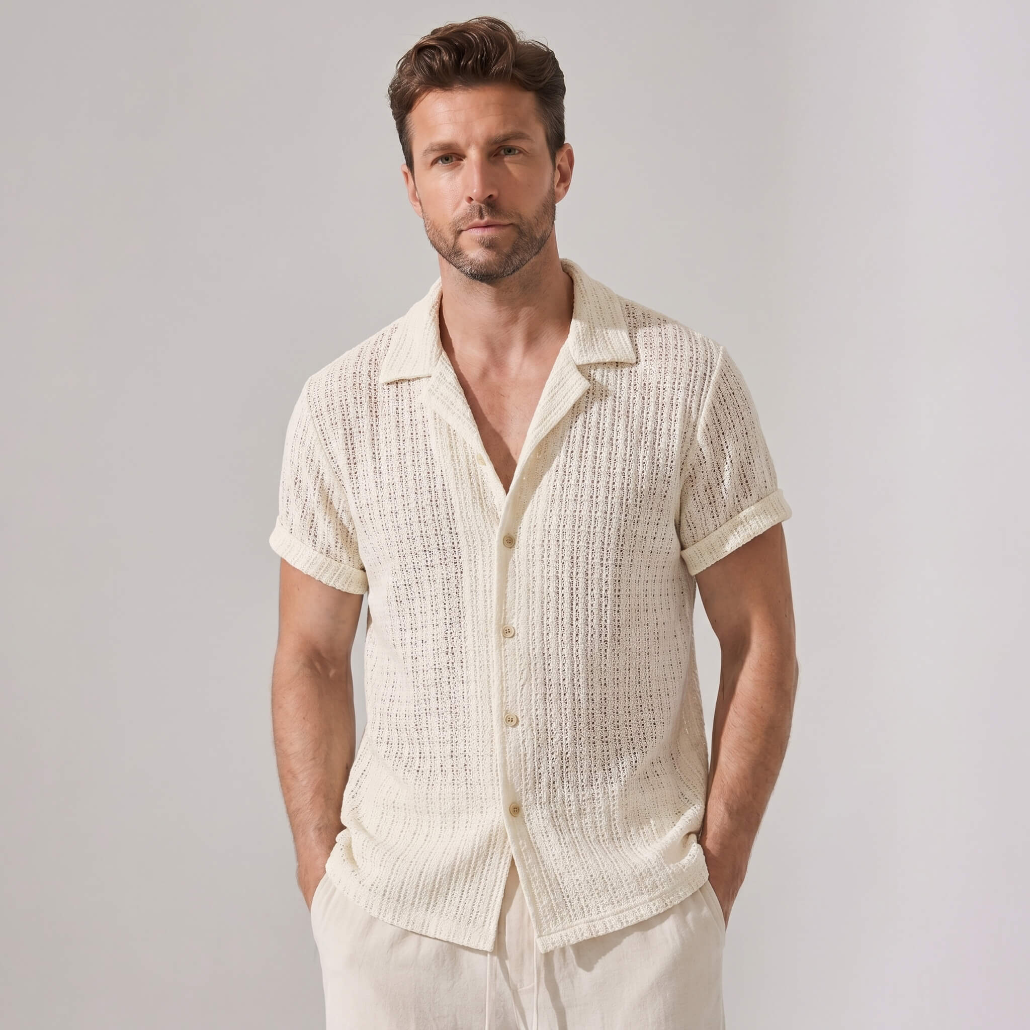 Man wearing a textured white shirt against a plain background