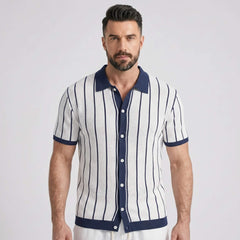 Man wearing a white and navy striped shirt with a collar on a light gray background