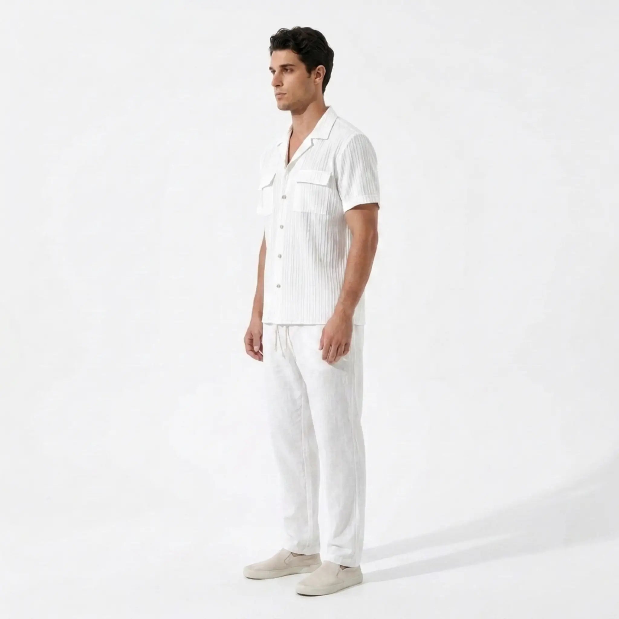 Man wearing a white shirt and pants on a white background