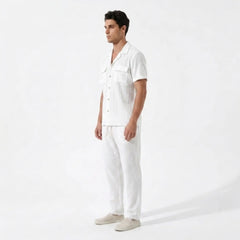Man wearing a white shirt and pants on a white background