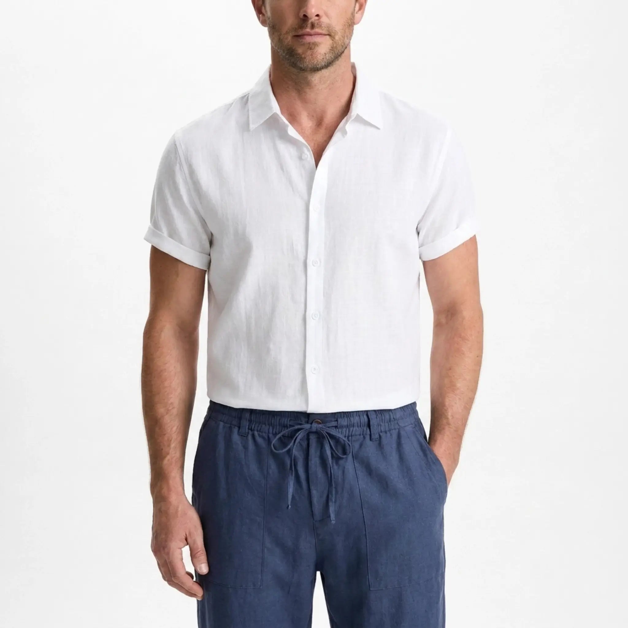Man wearing a white short-sleeve shirt and blue pants on a white background