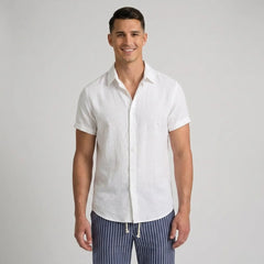 Man wearing a white short-sleeve shirt and striped pants on a gray background