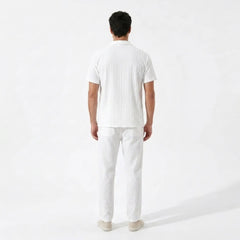 Man wearing a white t-shirt and pants on a white background