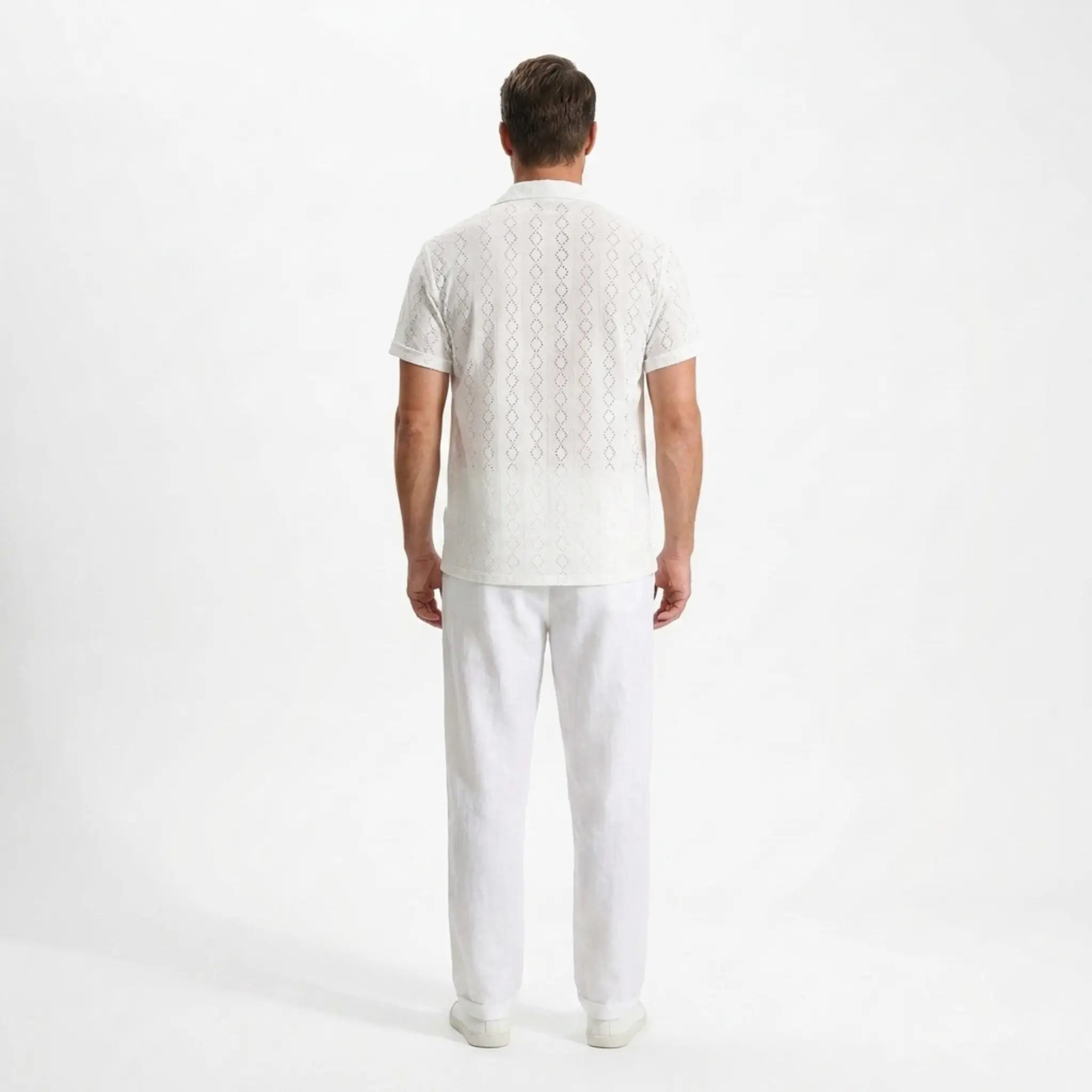 Man wearing a white outfit on a white background