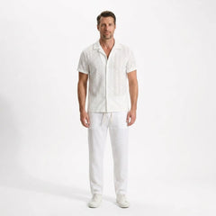 Man wearing a white shirt and pants on a white background
