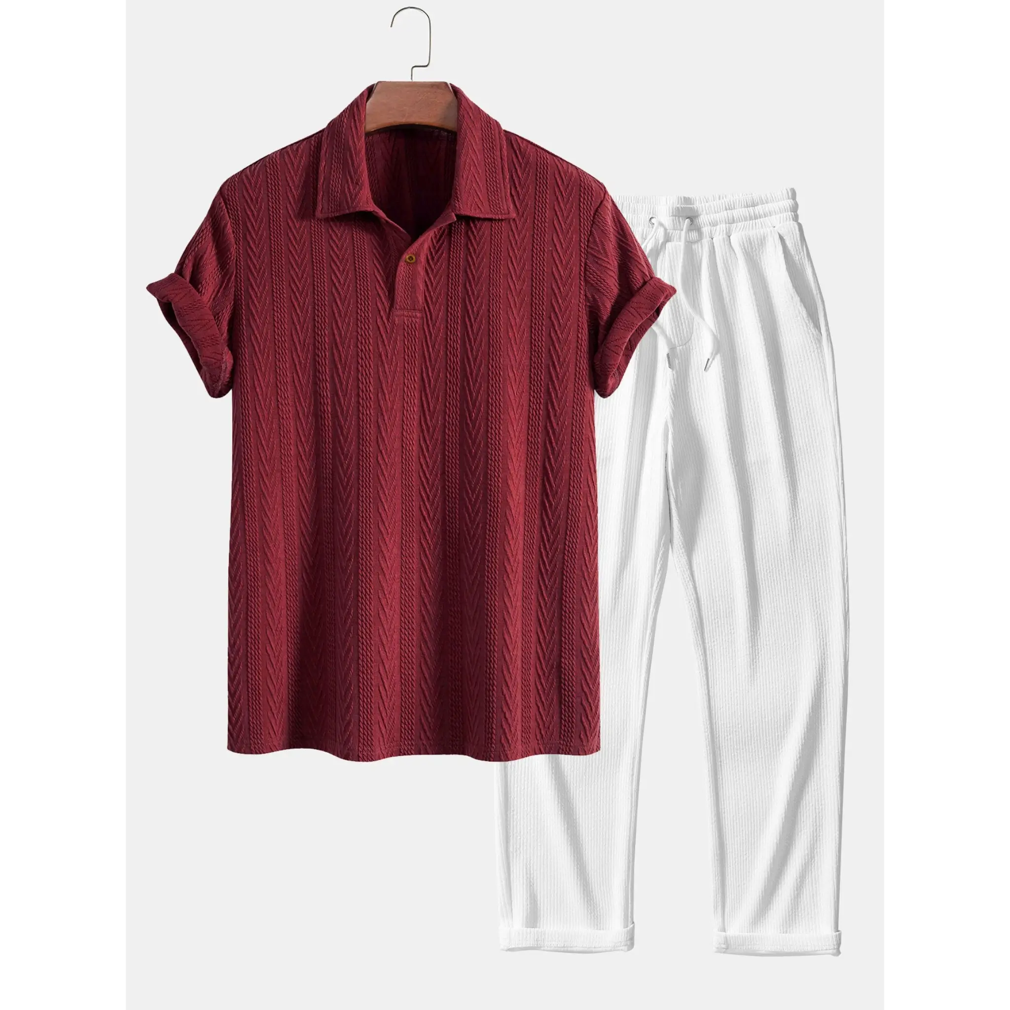Maroon textured shirt and white pants on a hanger against a white background