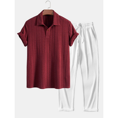 Maroon textured shirt and white pants on a hanger against a white background