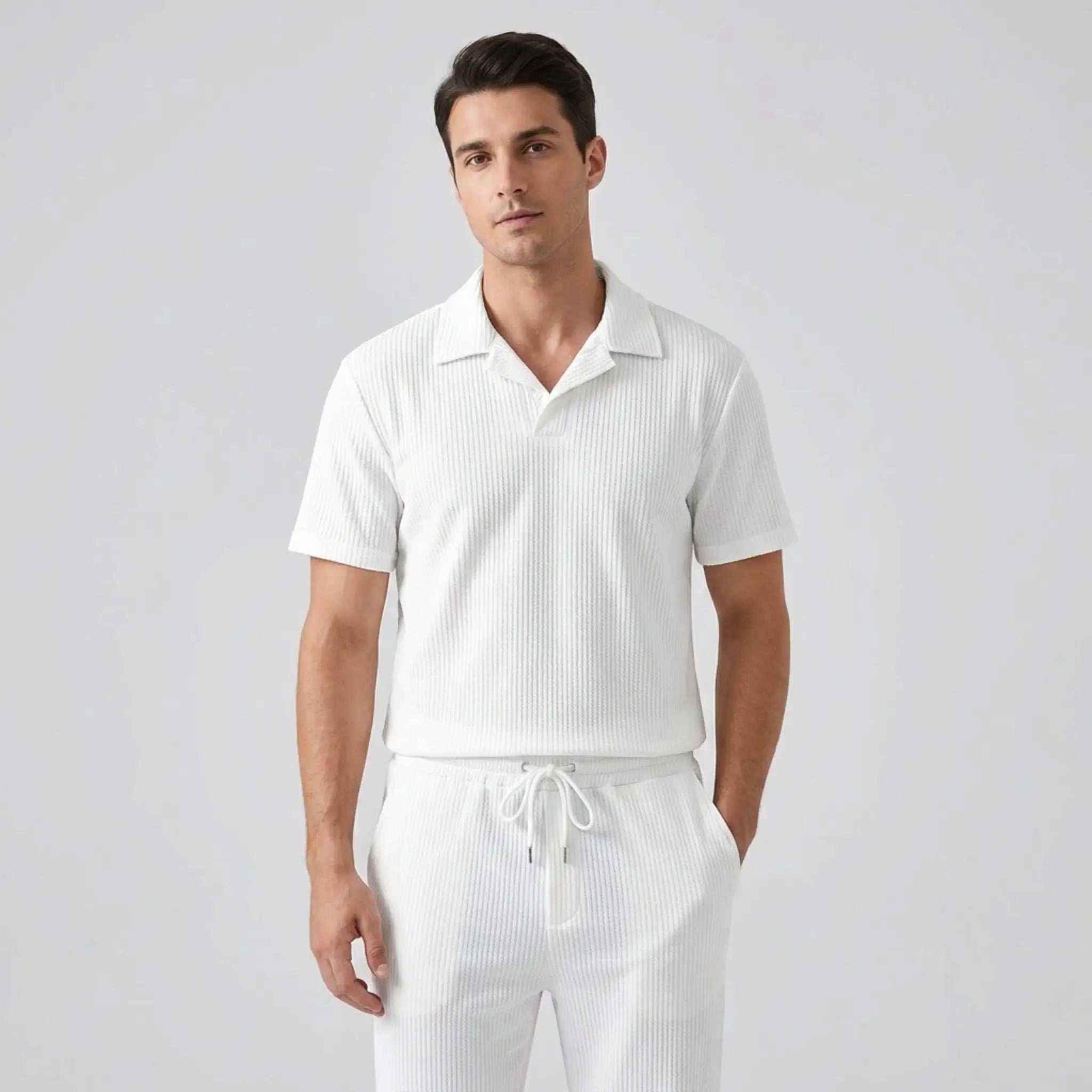 Model wearing white polo shirt and pant on white background with front view