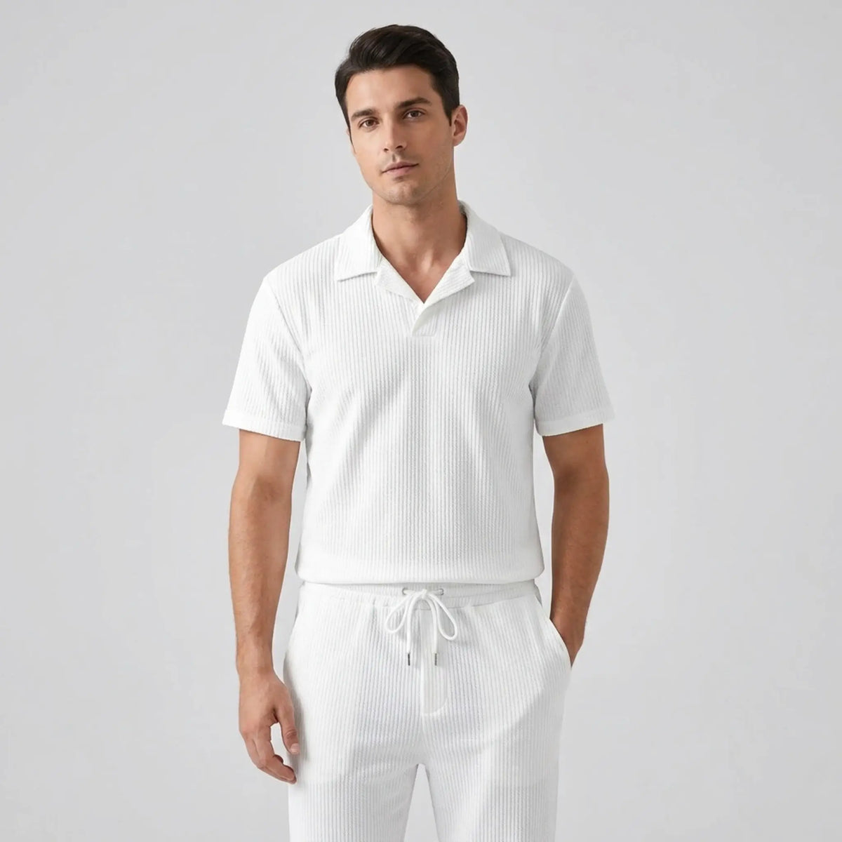 Model wearing white polo shirt and pant on white background with front view