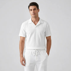 Model wearing white polo shirt and pant on white background with front view