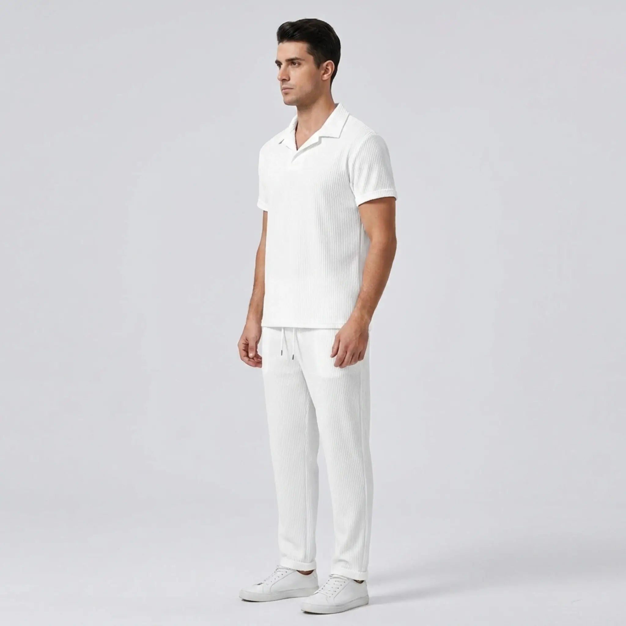 Model wearing white polo shirt and pant  side view on white background with front view