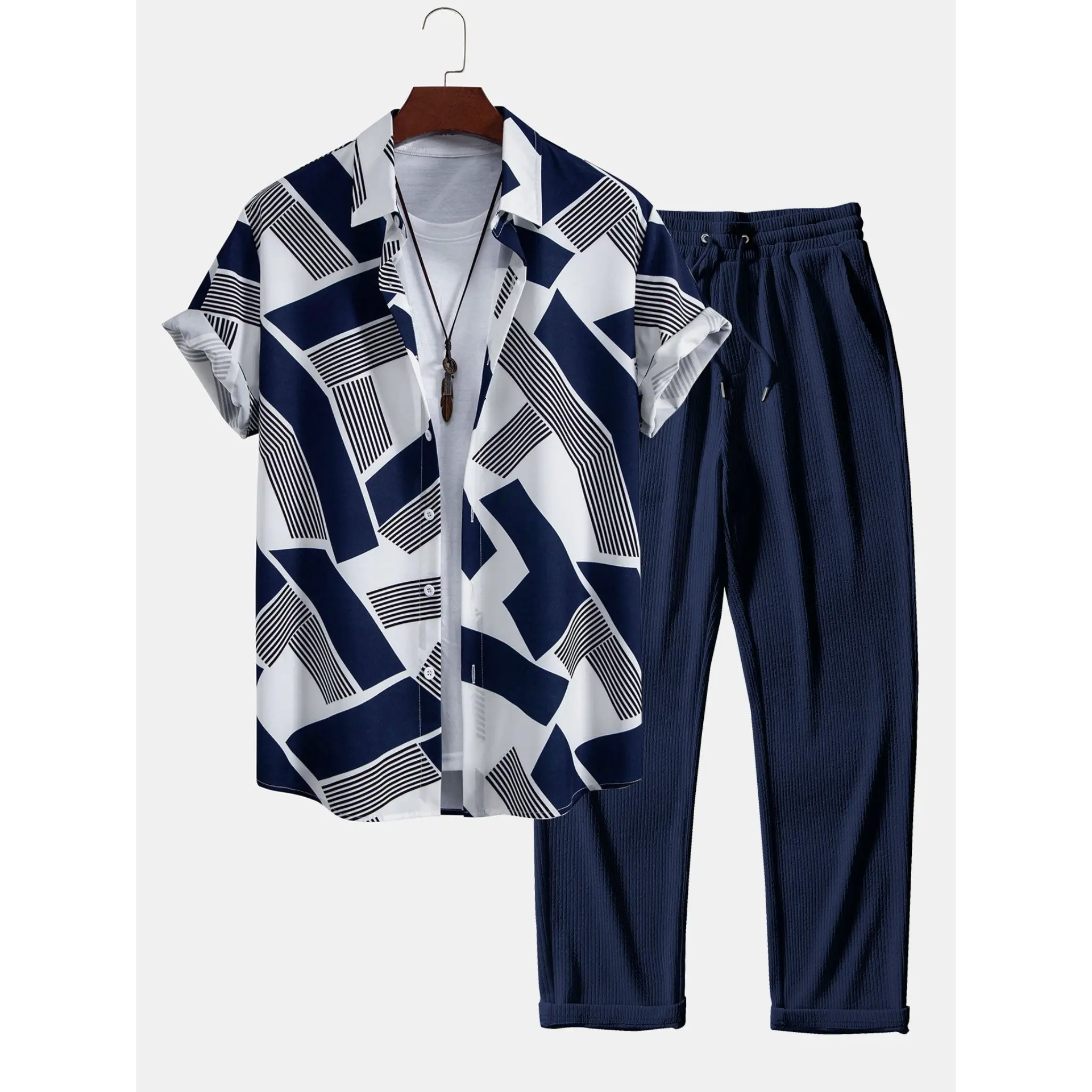 Navy and white patterned shirt with matching pants on a hanger against a white background