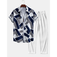 Navy and white patterned shirt with matching pants on a hanger against a white background