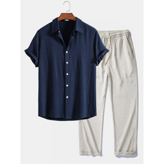 Navy shirt and beige striped pants on a hanger against a white background