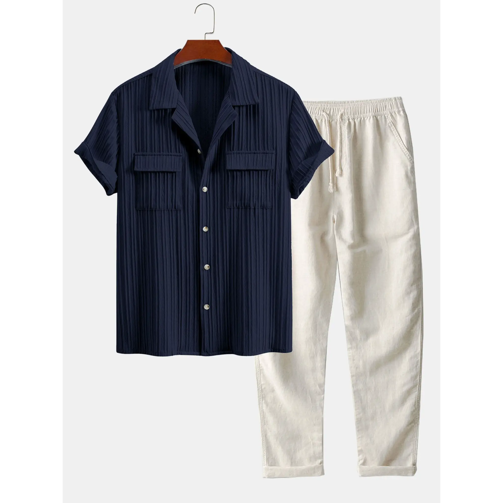 Navy shirt and white pants on a hanger against a white background