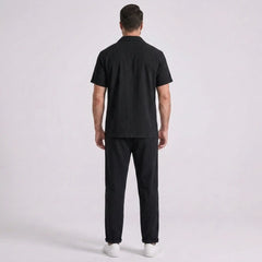 Person wearing a black outfit on a white background