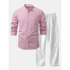 Pink checkered shirt and white pants on a light gray background