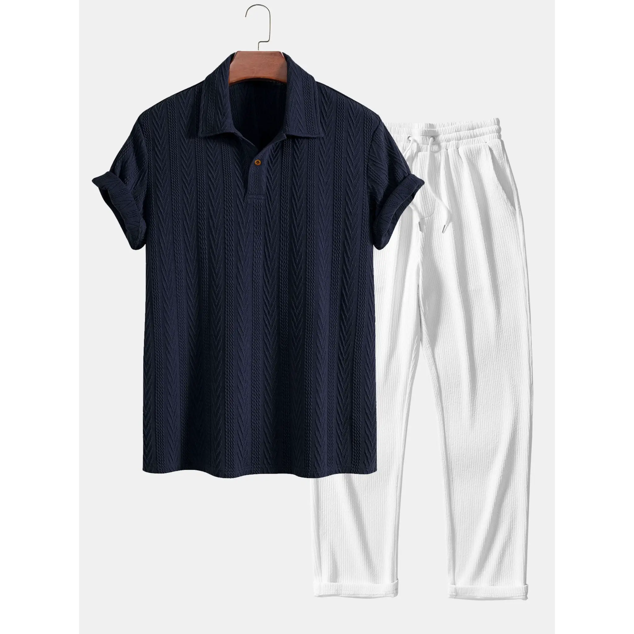 Black shirt and white pants on a hanger against a white background