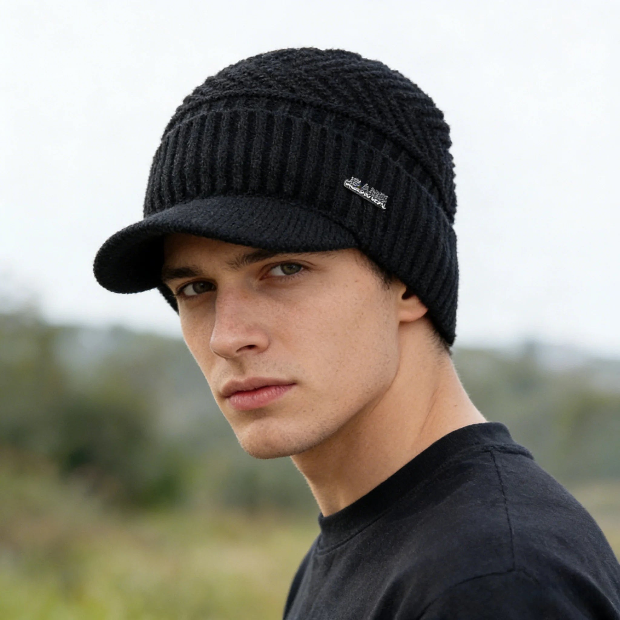 Man wearing a black fleece-lined knit beanie with brim outdoors