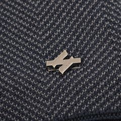 Close-up of the beanie's fine knit texture and metal badge
