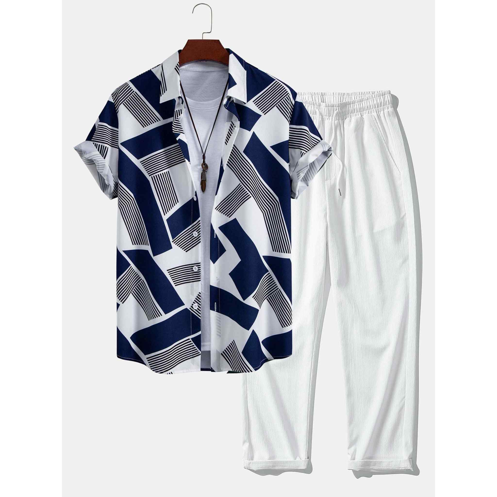 Shirt with geometric pattern and white pants on a hanger against a white background