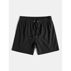 Solid black swim shorts isolated flat lay view