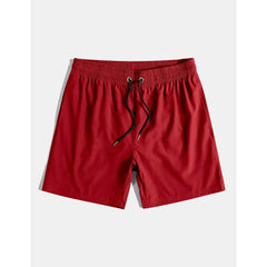 Solid red drawstring swim shorts flat lay front view