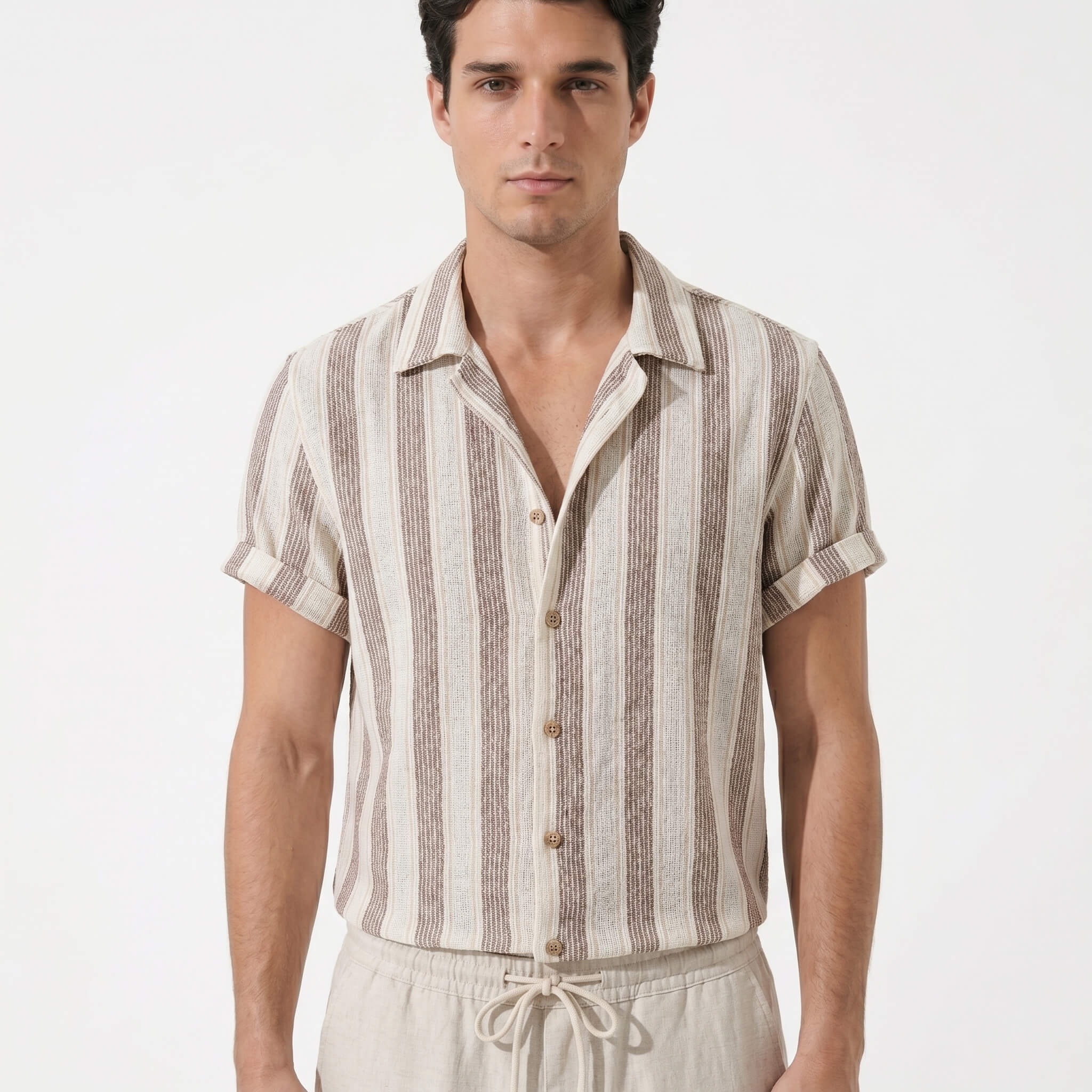 Man wearing a striped shirt and pants on a white background