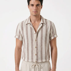 Man wearing a striped shirt and pants on a white background
