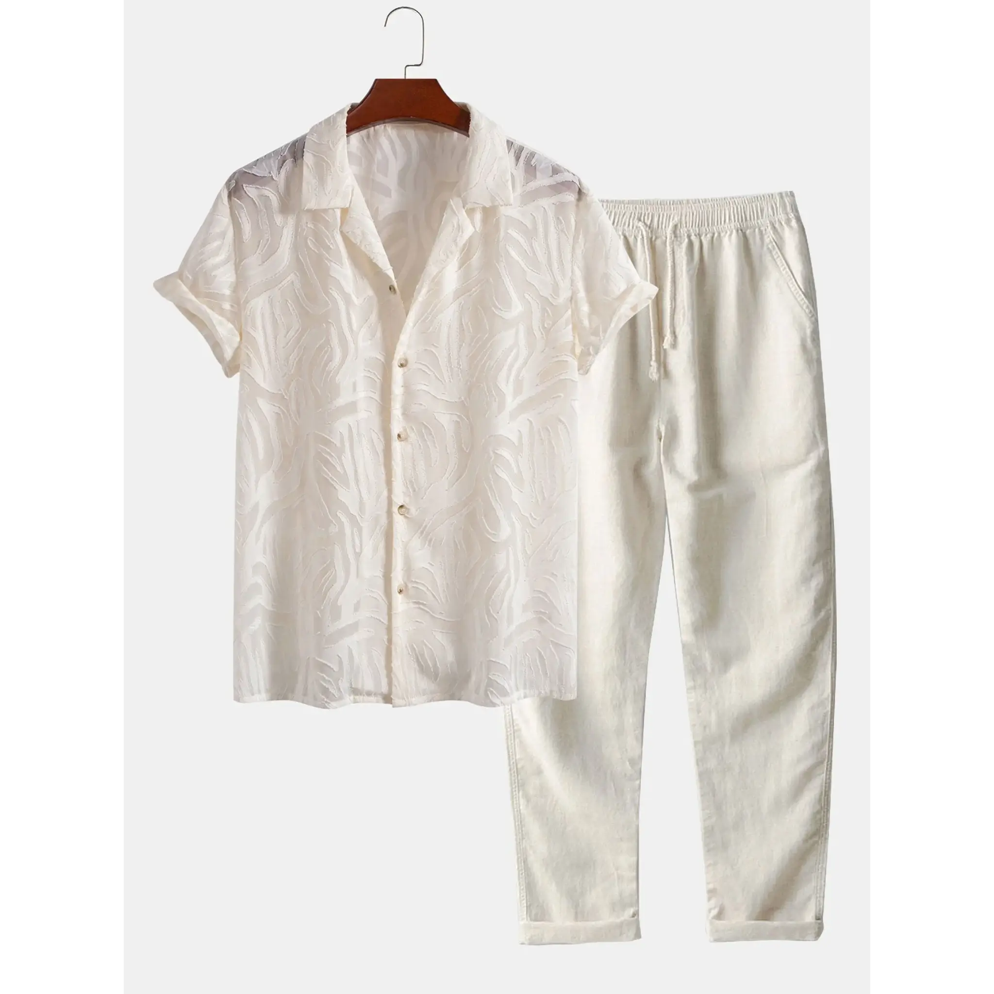 White linen shirt and pants set on a hanger against a white background