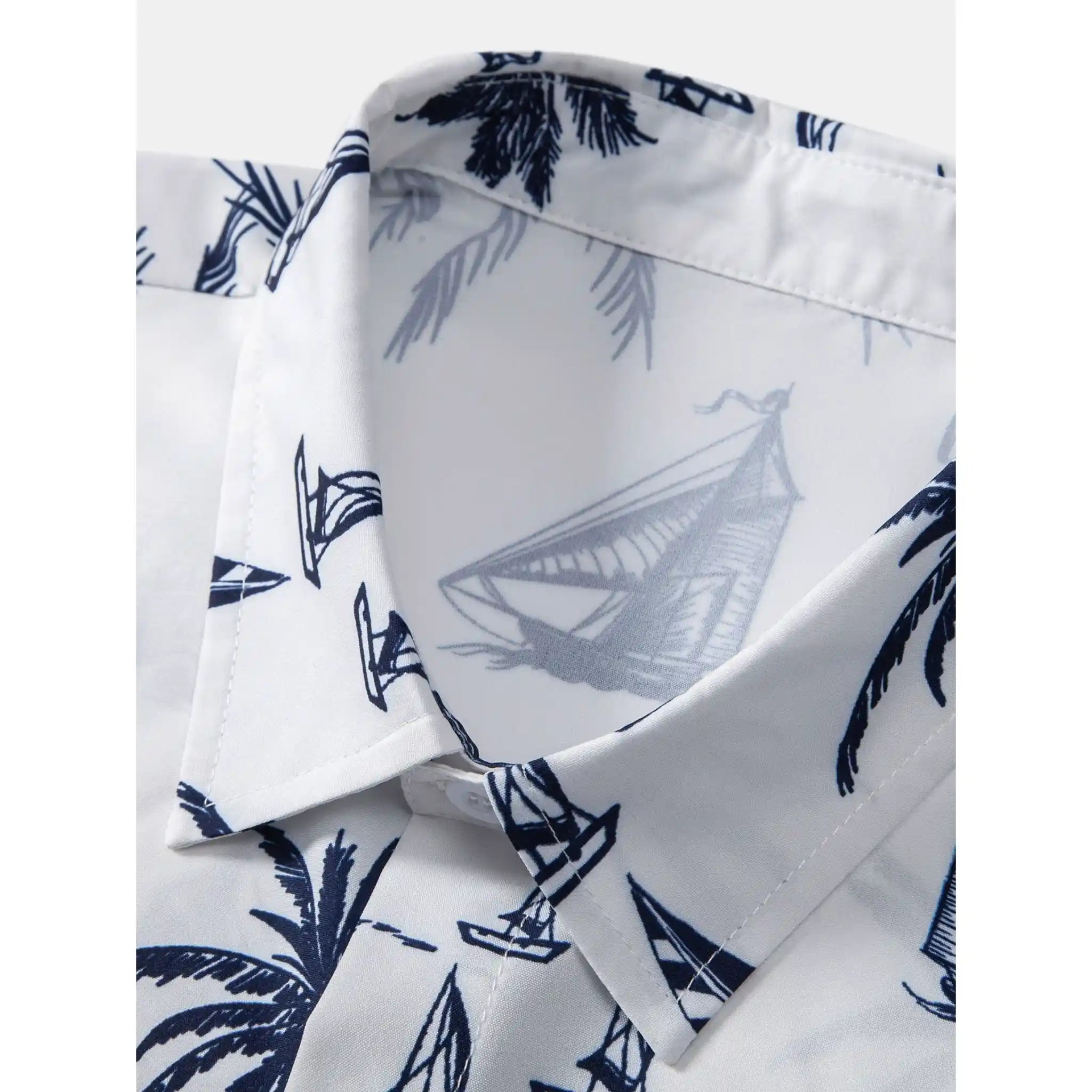 White shirt with blue palm tree and sailboat pattern
