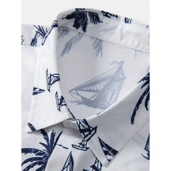 White shirt with blue palm tree and sailboat pattern