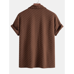 coffee textured shirt on a hanger against a white background