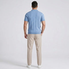 Back view of Man wearing a sky blue shirt with beige pants on a gray background