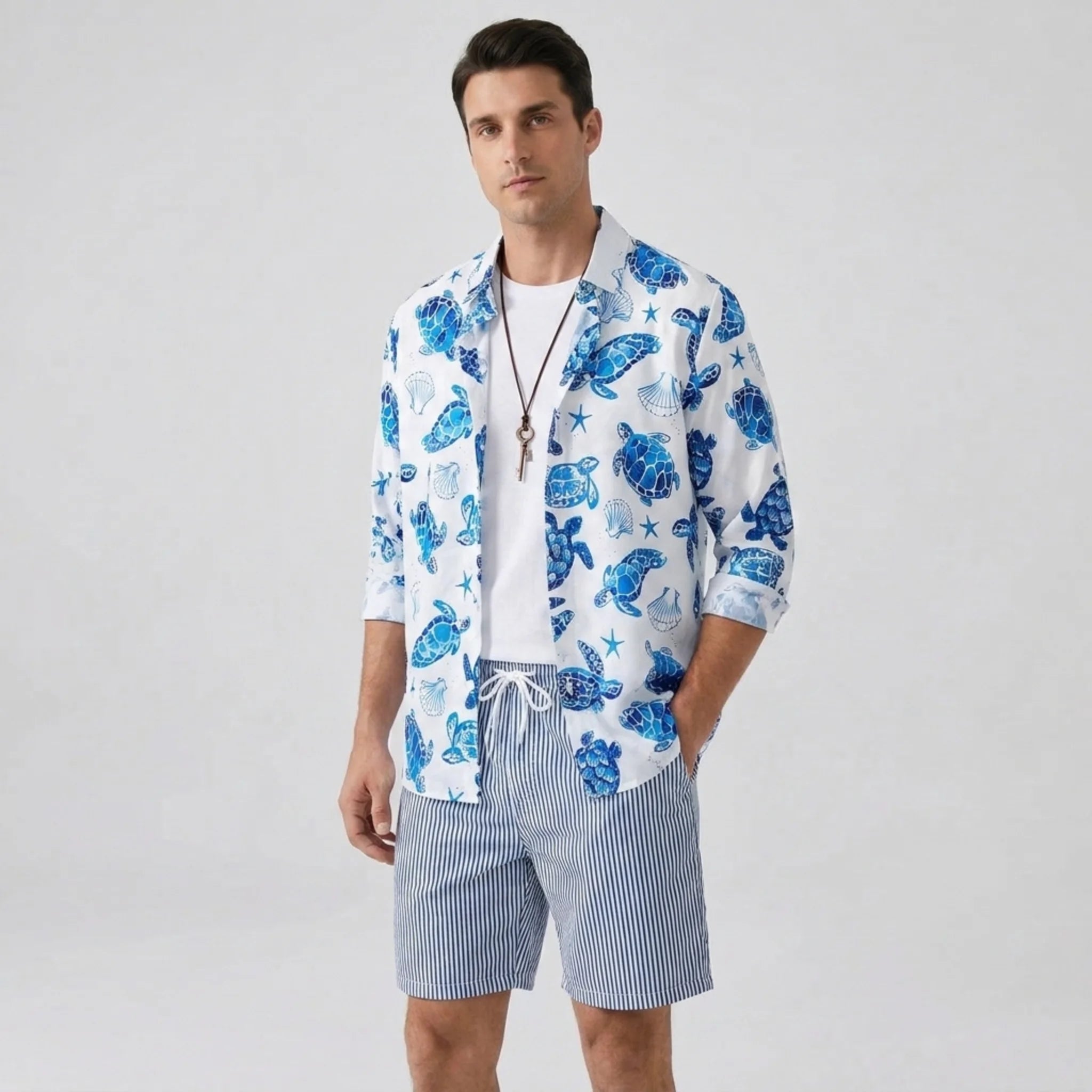 Full length view of man in black geometry textured Cuban shirt and straight leg linen pants on plain background
