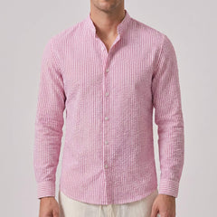 man wearing a pink checkered shirt front view on light grey background