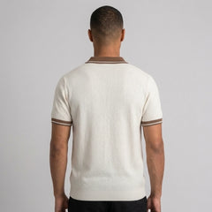 Back view of man wearing apricot color block knit polo shirt with lapel collar