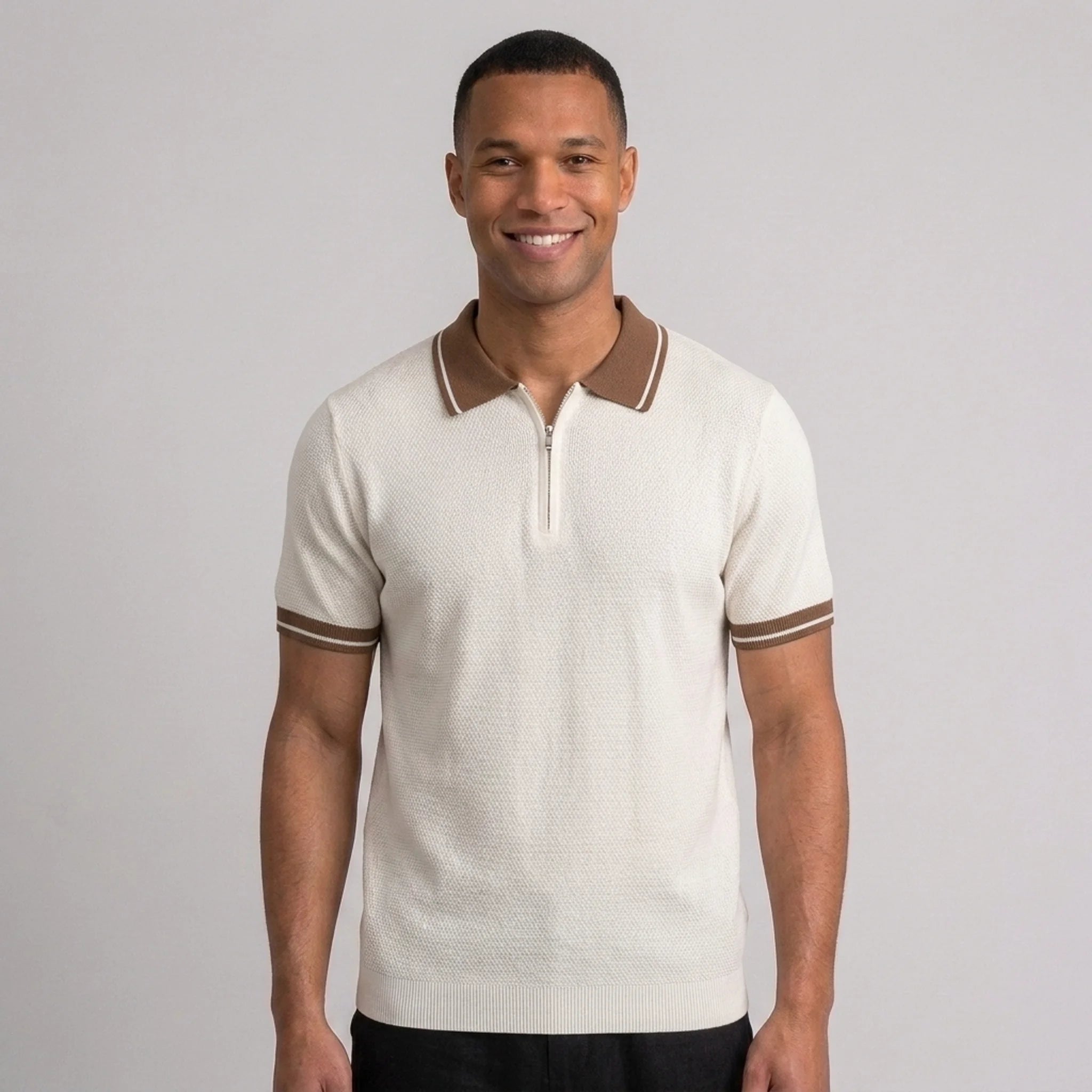 Man wearing an apricot color block knit polo shirt with lapel collar front view