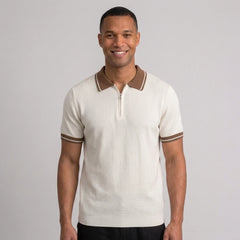 Man wearing an apricot color block knit polo shirt with lapel collar front view