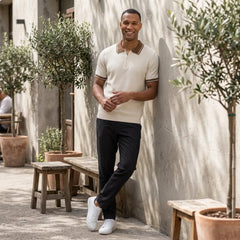 Man in apricot color block knit polo shirt in sunny outdoor scene