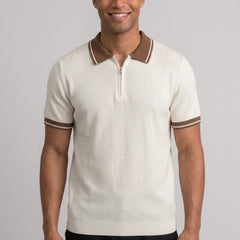 Side view of man in apricot color block knit polo shirt with lapel collar