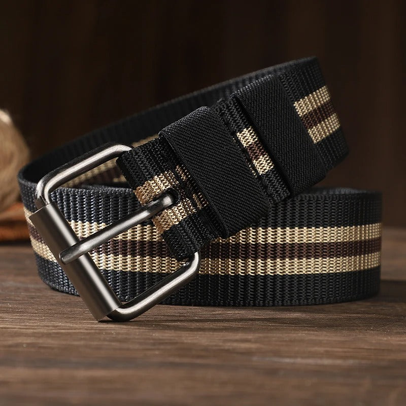 Close up of silver pin buckle on army green striped canvas braided belt showing adjustment holes
