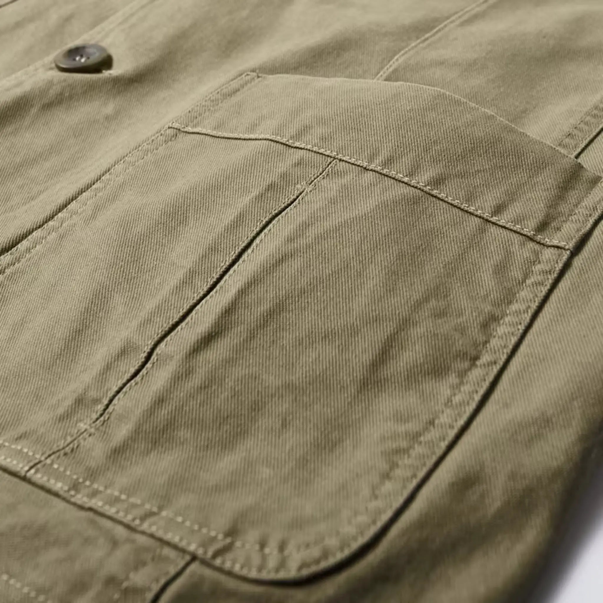 MannerCo army green washed cotton jacket close-up pocket and button detail