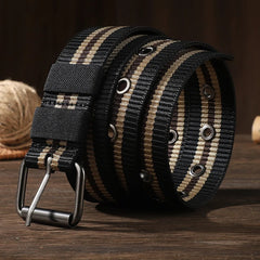 Man wearing army green striped canvas braided belt with silver pin buckle on casual outdoor outfit