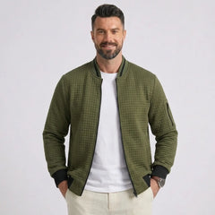 Man wearing MannerCo army green quilted zip-up baseball jacket with stand collar, front view