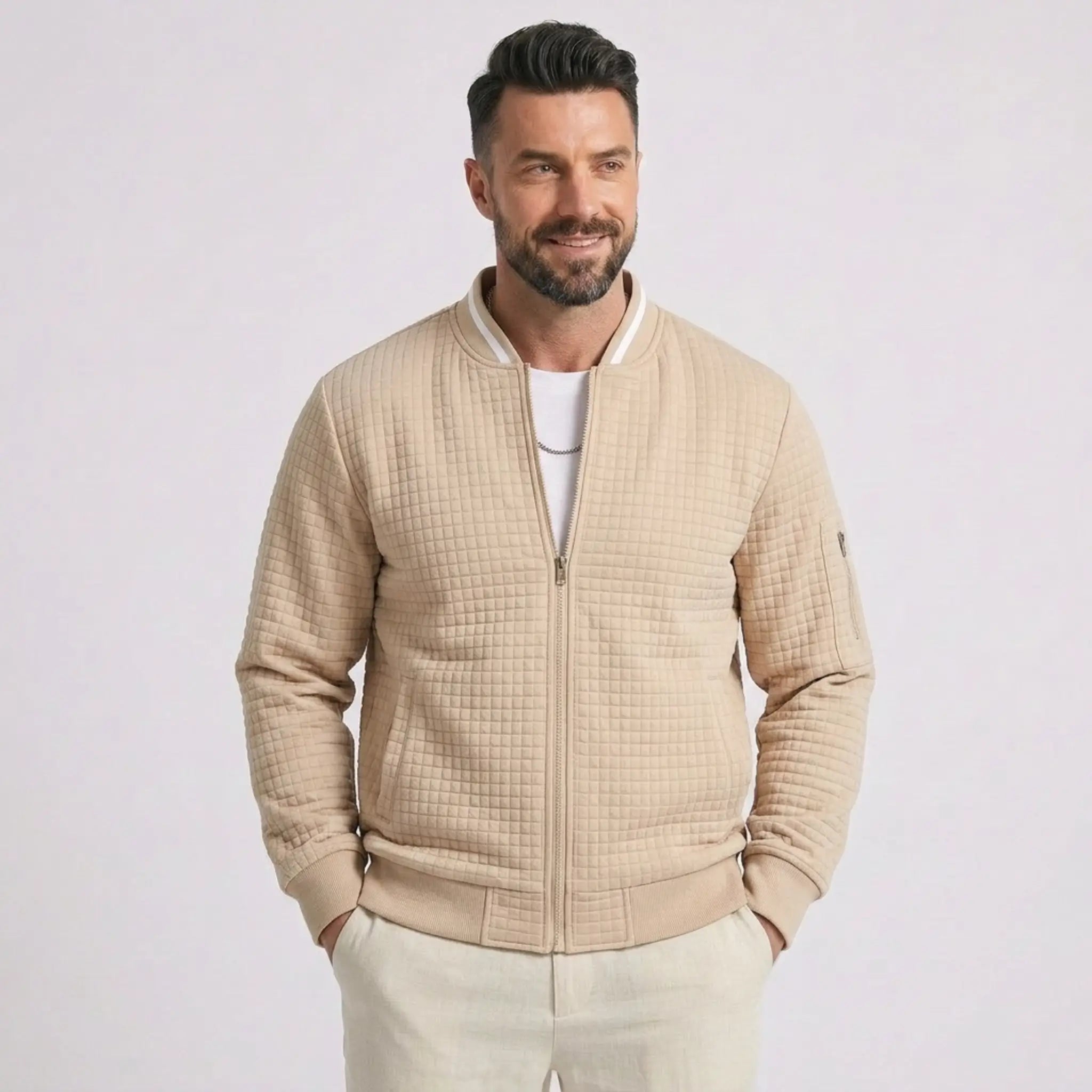 Man wearing MannerCo khaki quilted zip-up baseball jacket with stand collar, front view