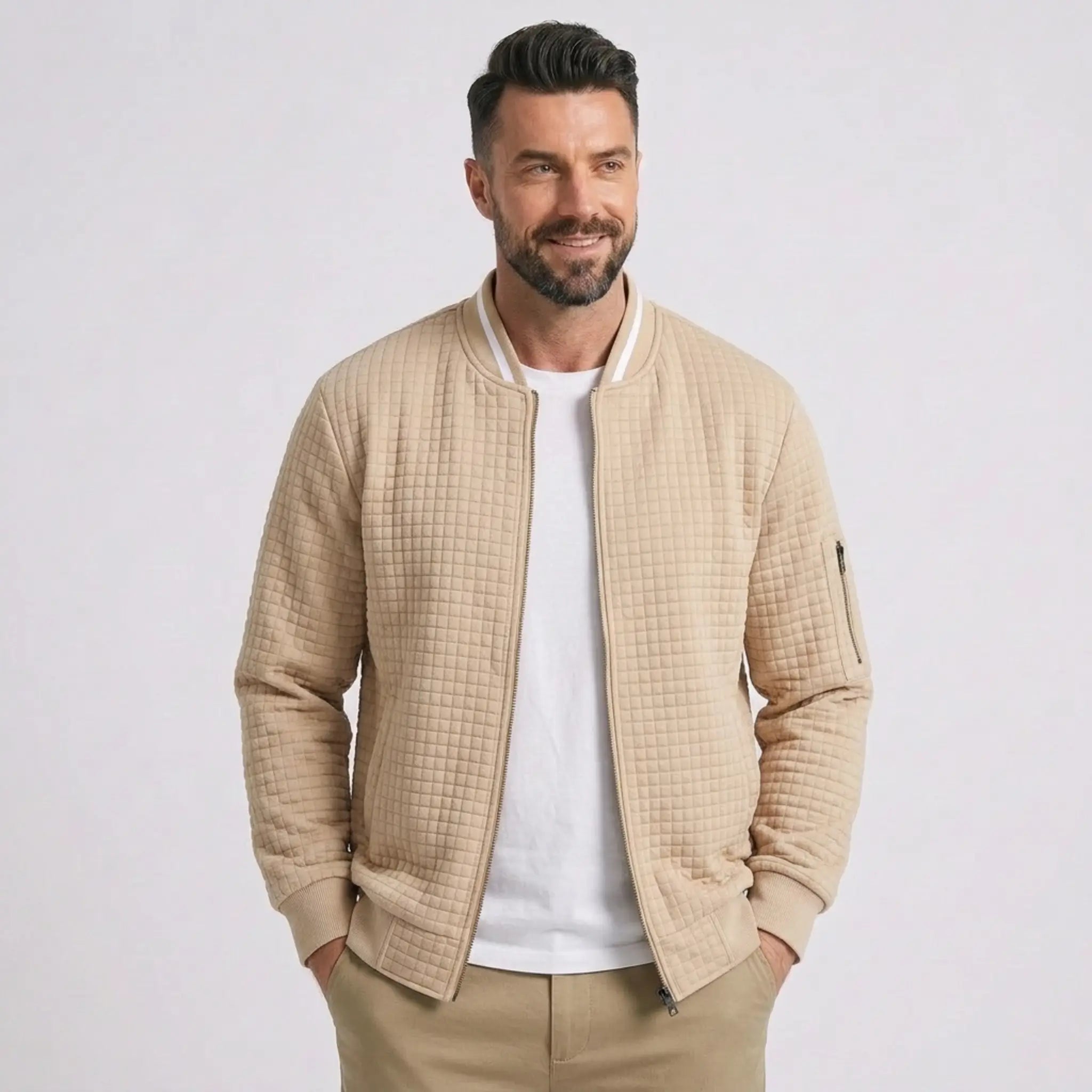 Man wearing MannerCo khaki quilted zip-up baseball jacket with stand collar, front view