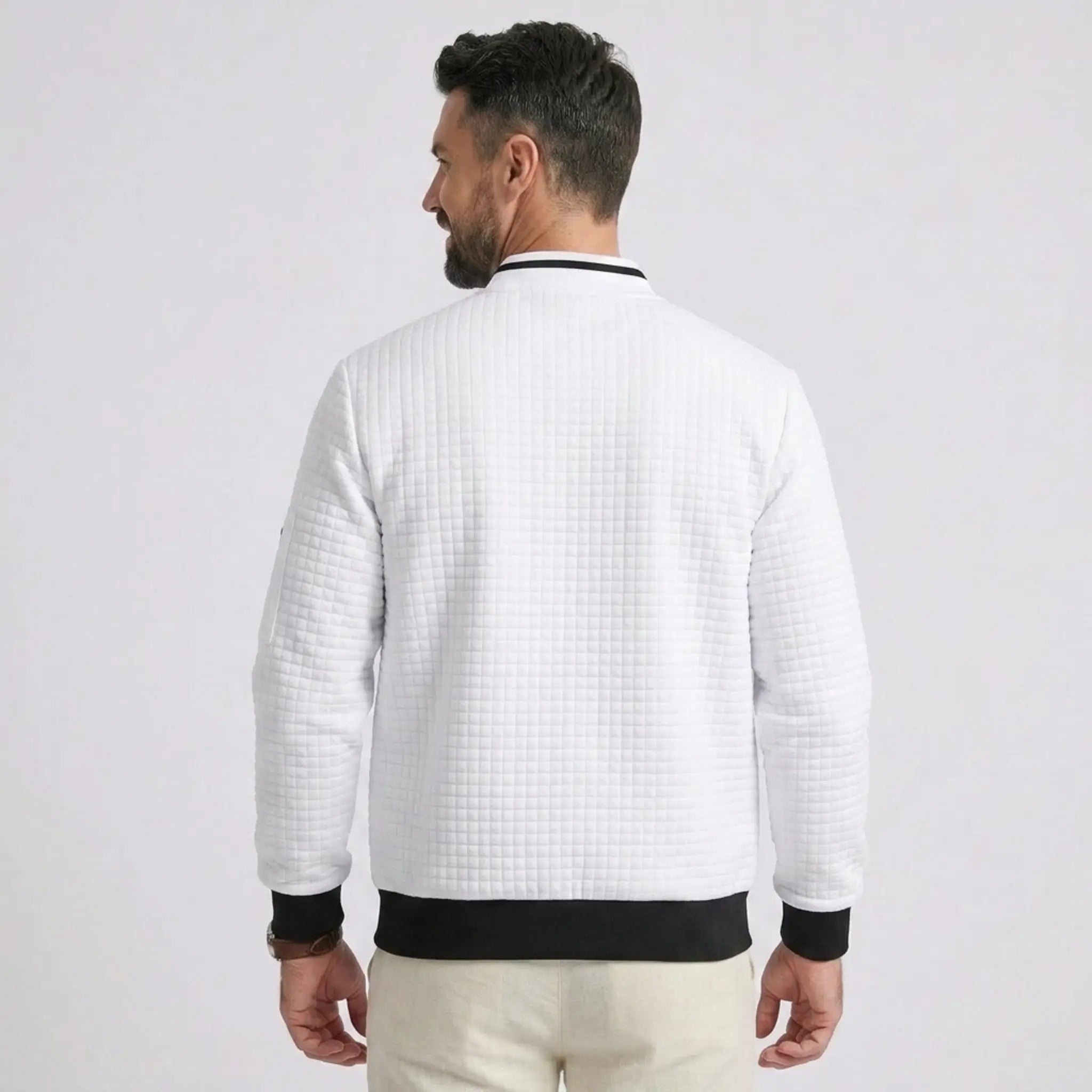 MannerCo white quilted zip-up baseball jacket with black collar and cuffs, back view