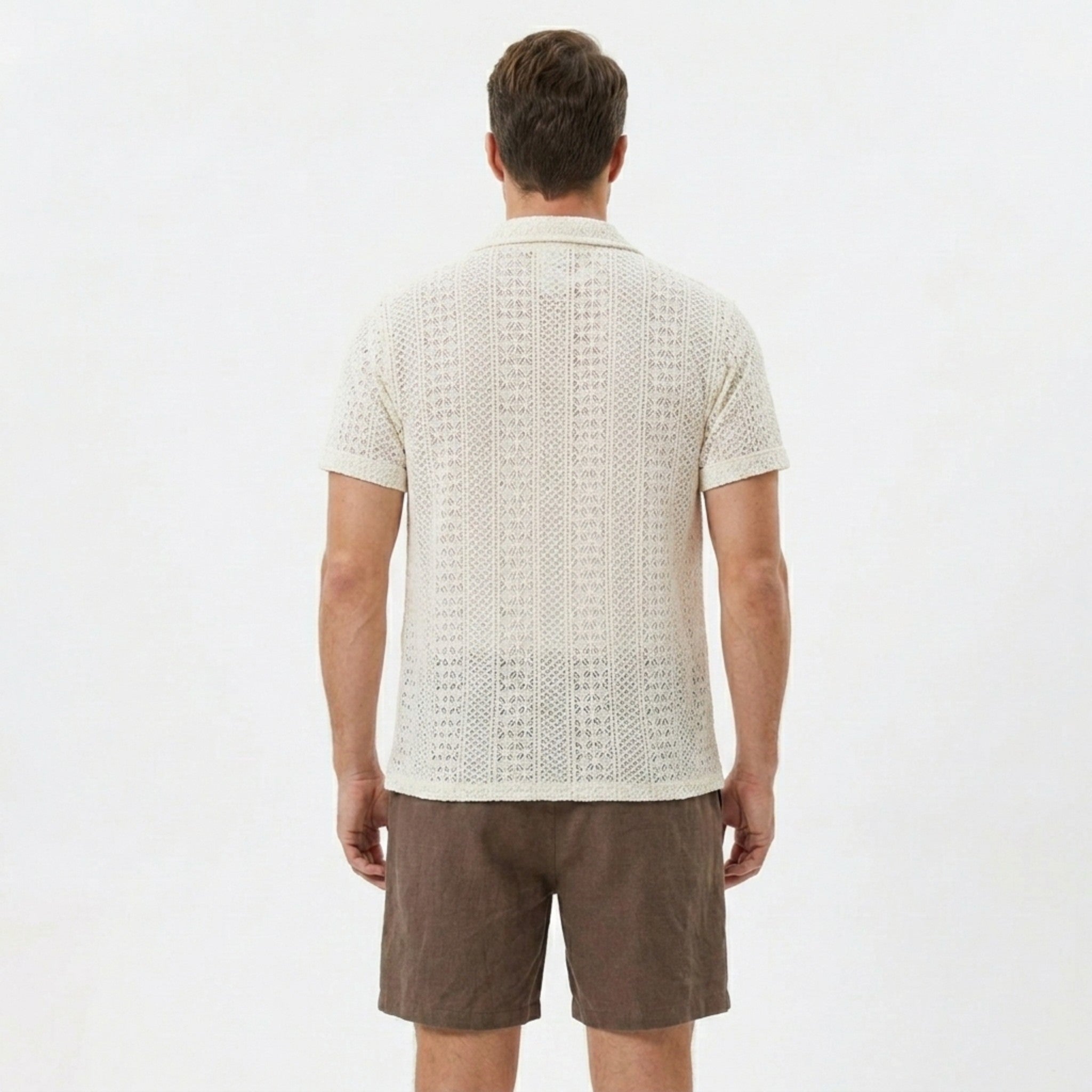 Man wearing beige floral checkerboard jacquard Cuban shirt and linen cotton drawstring shorts front view