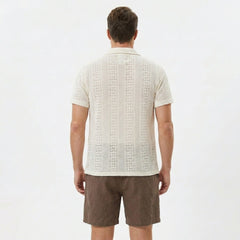 Man wearing beige floral checkerboard jacquard Cuban shirt and linen cotton drawstring shorts front view